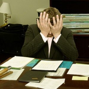 Frustrated_man_at_a_desk_cropped-300x300